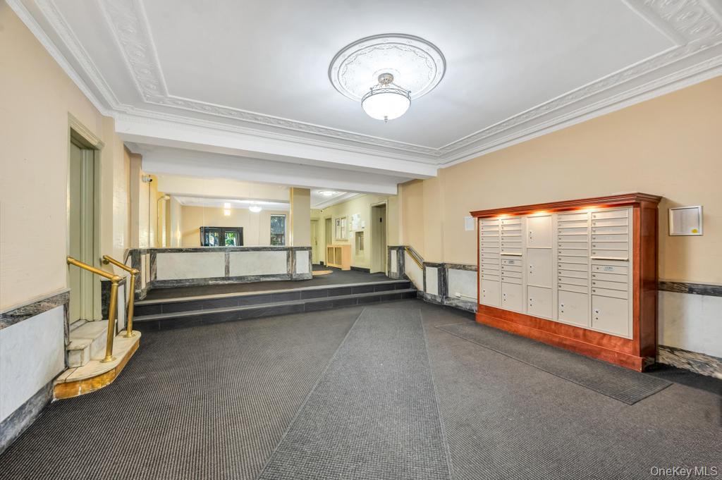 83-64 Talbot Street, Unit 3A Queens, NY 11415 - Photo 10 of 15 Building entryway featuring decorative ceiling molding and a built-in mailbox system with overhead illumination