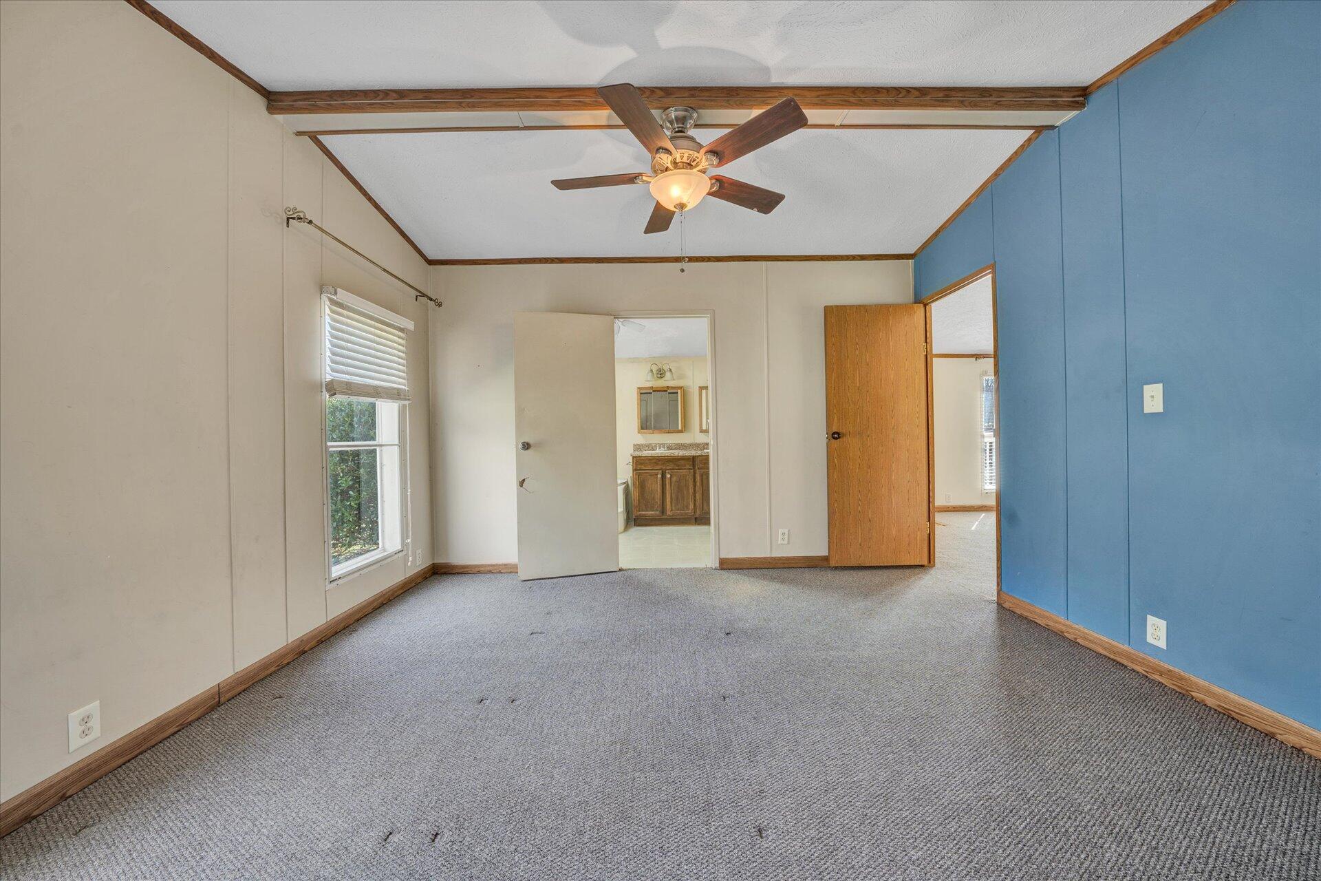 2121 Cannady School Road Southeast Floyd, VA 24091 - Photo 14 of 41 an empty room with chandelier fan and windows