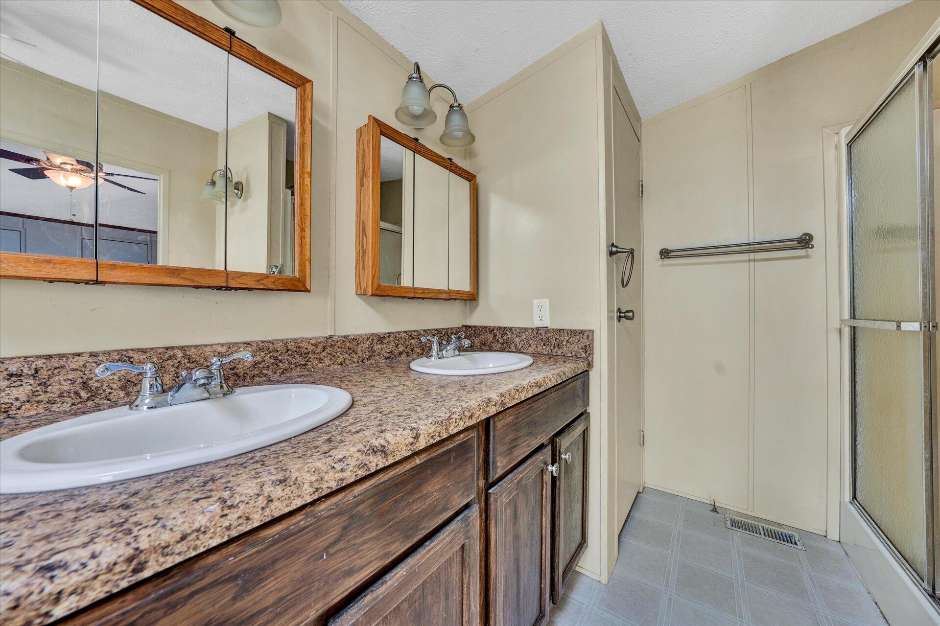 2121 Cannady School Road Southeast Floyd, VA 24091 - Photo 16 of 41 a bathroom with a granite countertop sink and a mirror
