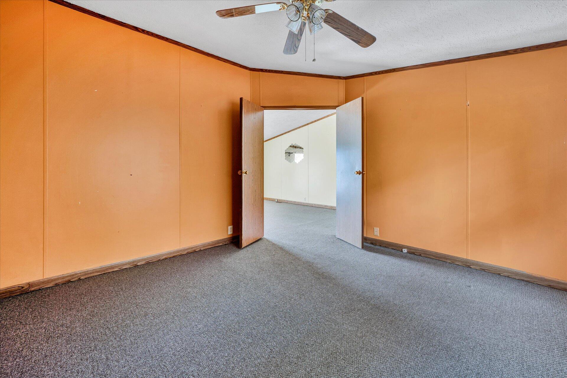 2121 Cannady School Road Southeast Floyd, VA 24091 - Photo 18 of 41 an empty room with a ceiling fan and painted walls