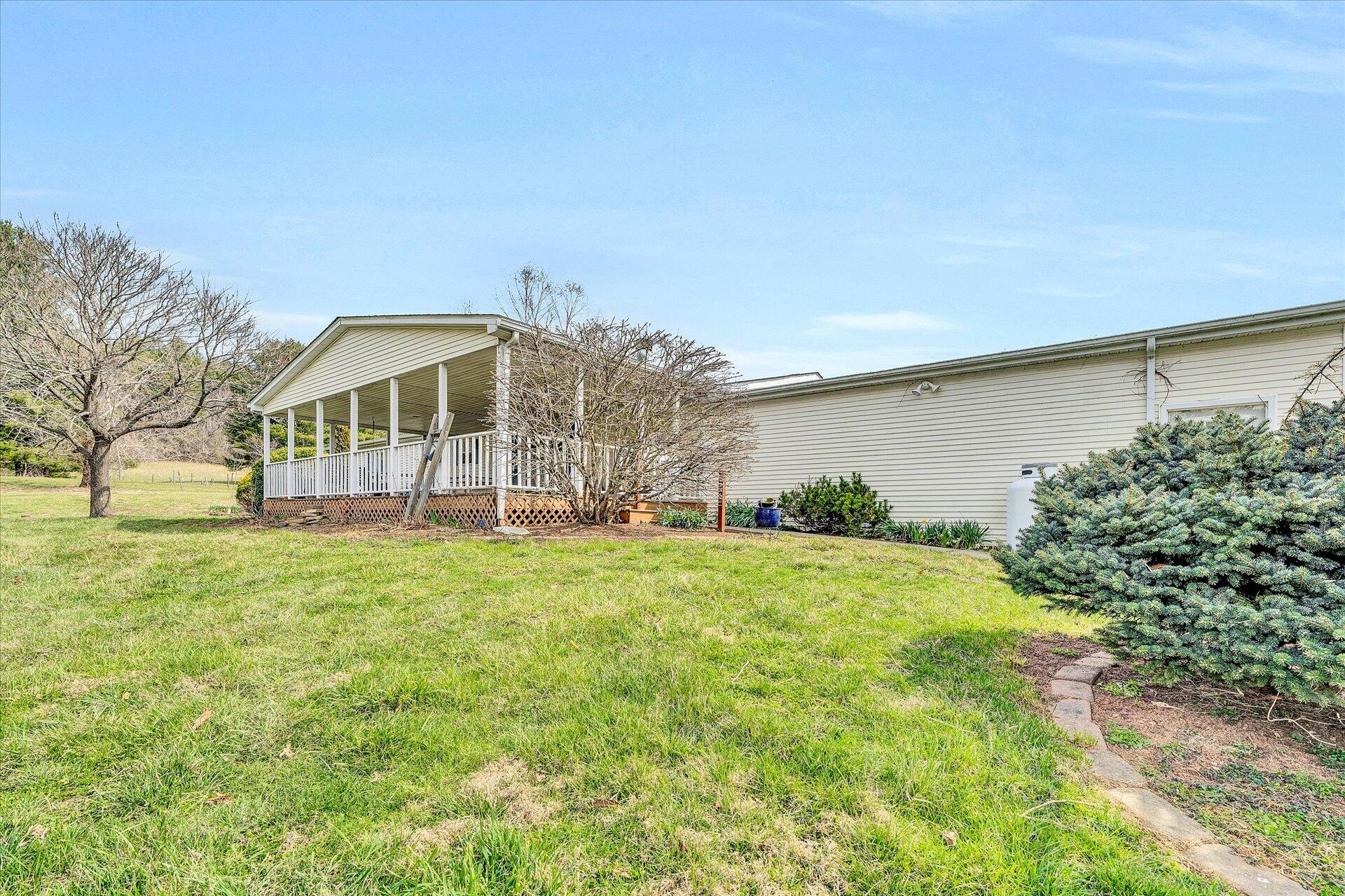 2121 Cannady School Road Southeast Floyd, VA 24091 - Photo 41 of 41 a view of a house with a big yard and potted plants