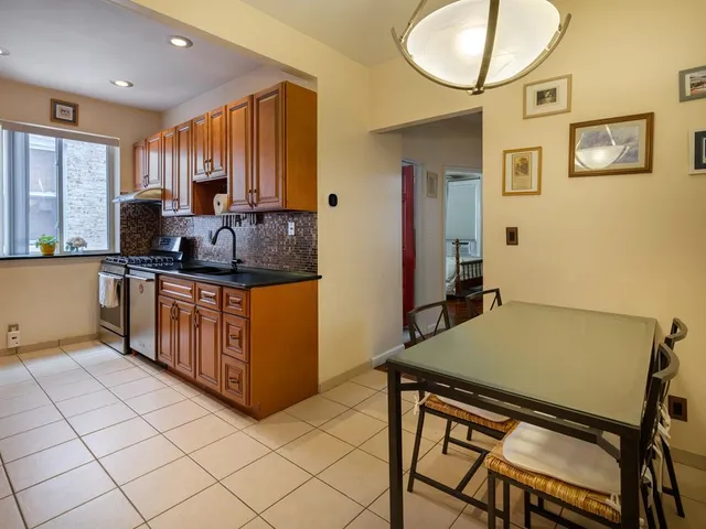a kitchen with stainless steel appliances granite countertop a stove a sink a refrigerator and a microwave