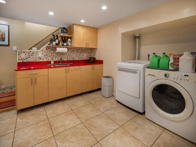 a view of a kitchen with washing machine and a sink
