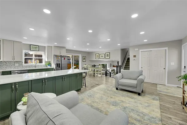 a living room with furniture and view of kitchen