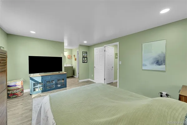 a bedroom with a bed and a flat screen tv