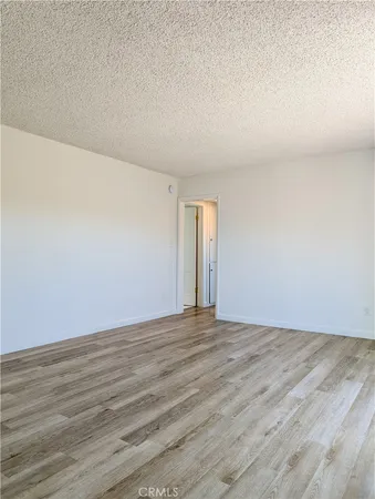 a view of an empty room and wooden floor
