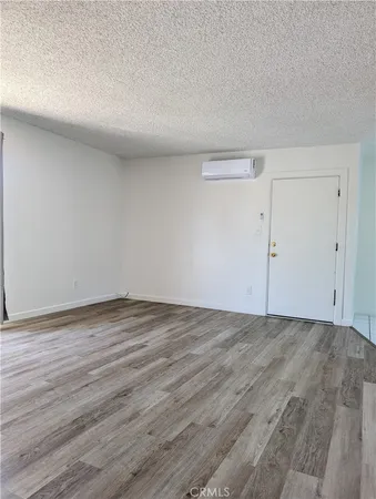 a view of an empty room and wooden floor