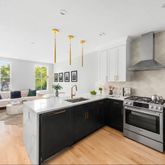 a kitchen with stainless steel appliances a sink stove and cabinets