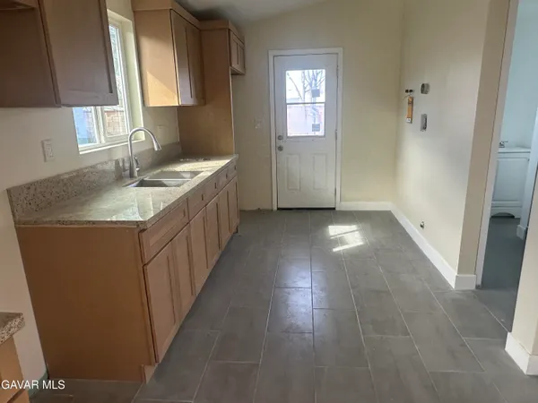 a bathroom with sink shower and mirror