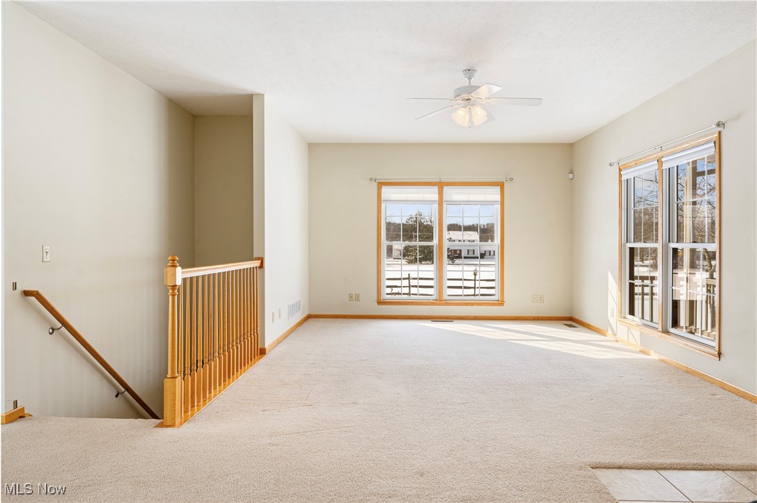 706 Watson Road Deerfield, OH 44411 - Photo 4 of 36 Carpeted empty room with ceiling fan
