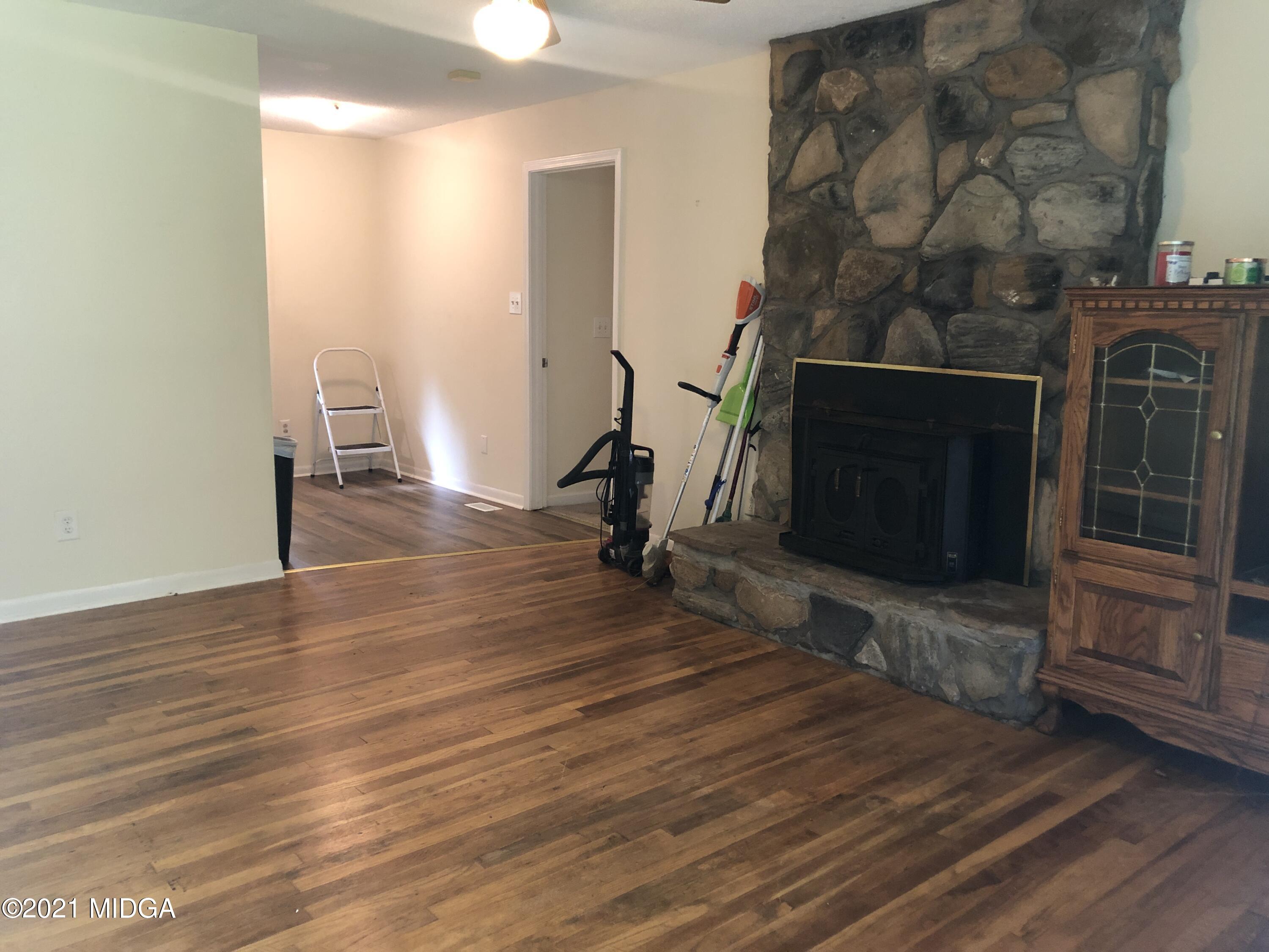 339 Wheeler Road Gray, GA 31032 - Photo 2 of 11 a view of empty room with wooden floor and fan
