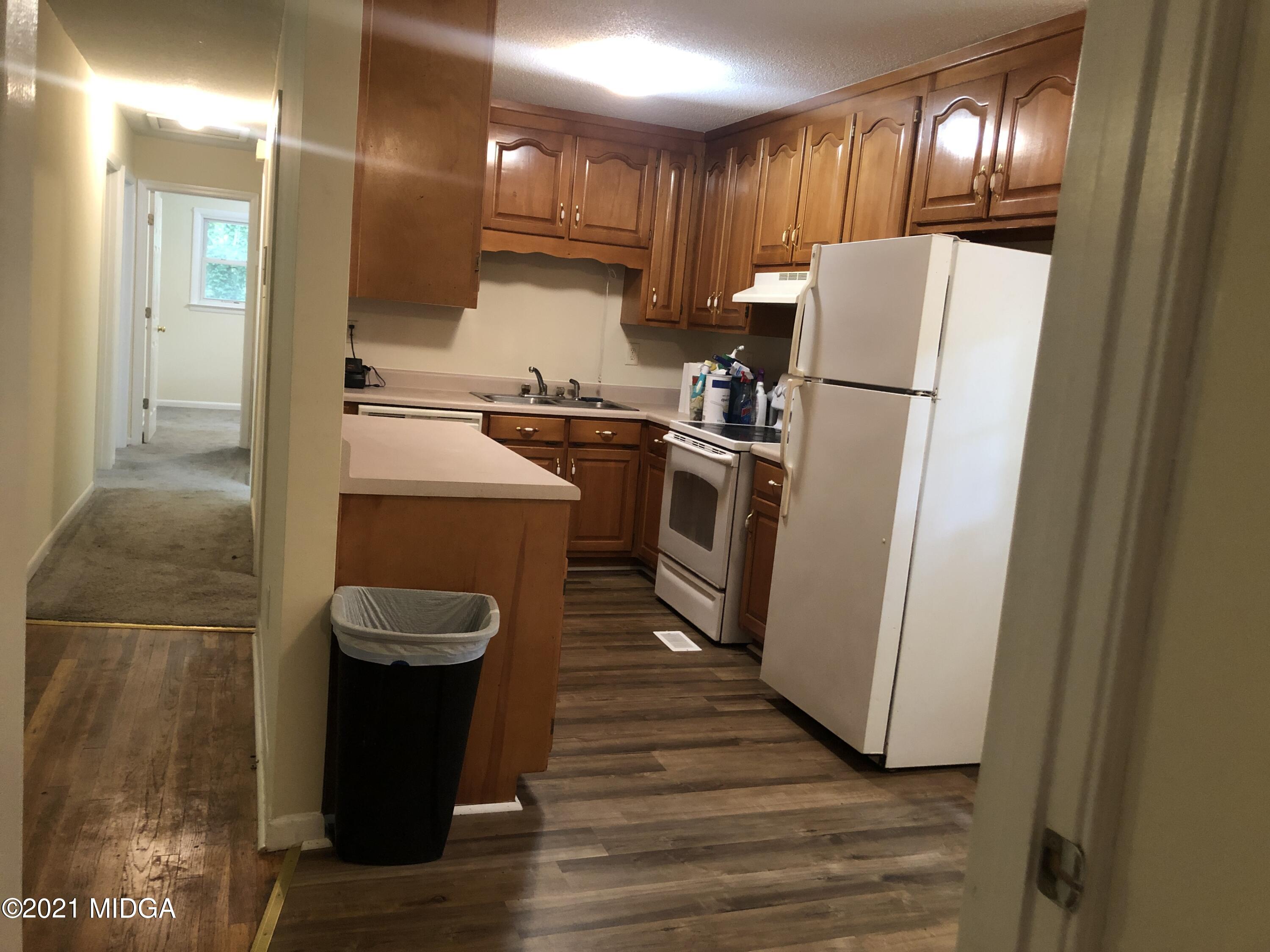339 Wheeler Road Gray, GA 31032 - Photo 3 of 11 a kitchen with a refrigerator a stove and wooden floor