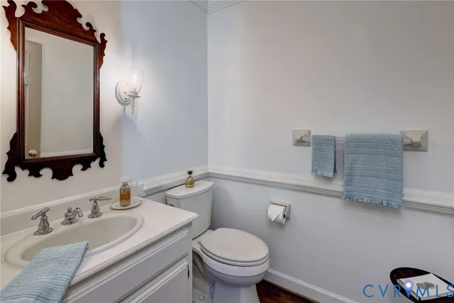 a bathroom with a granite countertop toilet sink and mirror