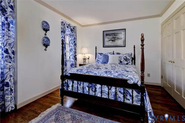 a bed sitting in a bedroom next to a small bathroom