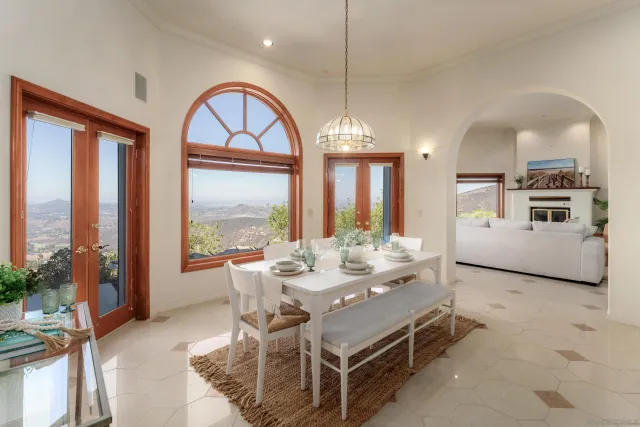 a view of wooden floor fire place and windows in a room