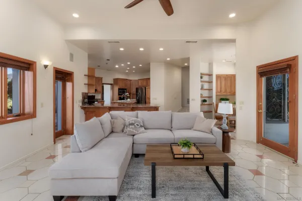 a view of an empty room with wooden floor fireplace and a window