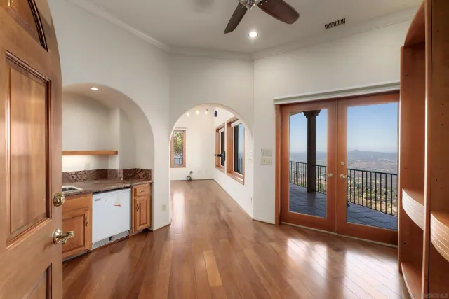 a bathroom with a tub a sink and a large mirror