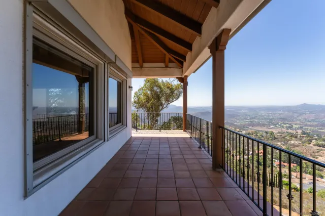 a bathroom with a granite countertop sink toilet a mirror and shower