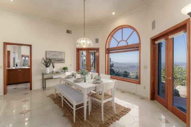 a view of a dining room with furniture and chandelier
