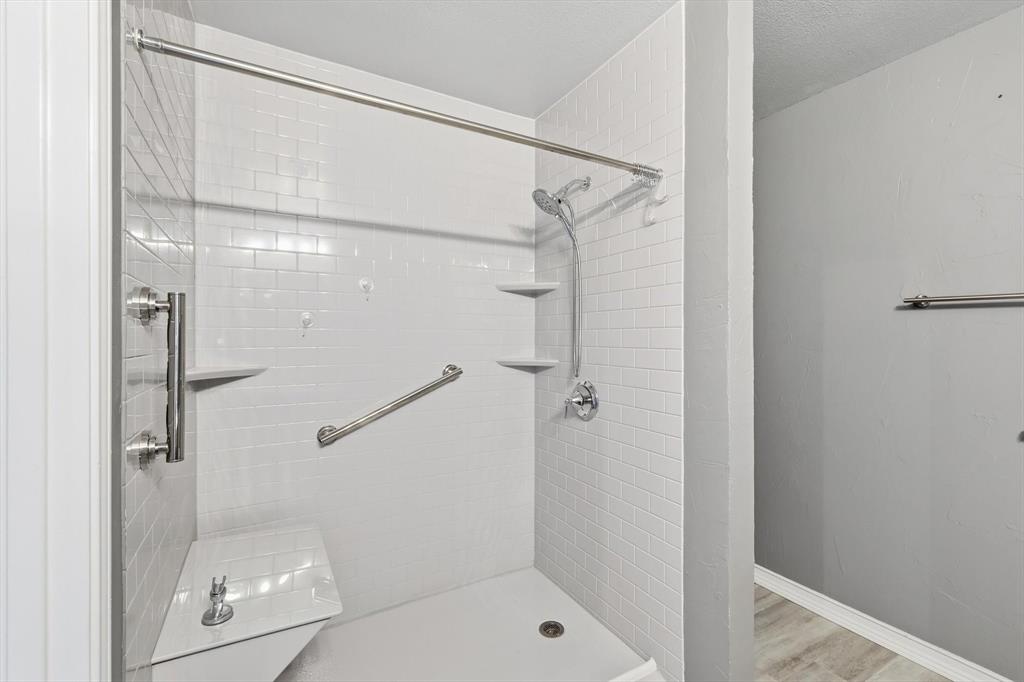 205 Broken Arrow Lane Krum, TX 76249 - Photo 17 of 28 a bathroom with a glass shower door