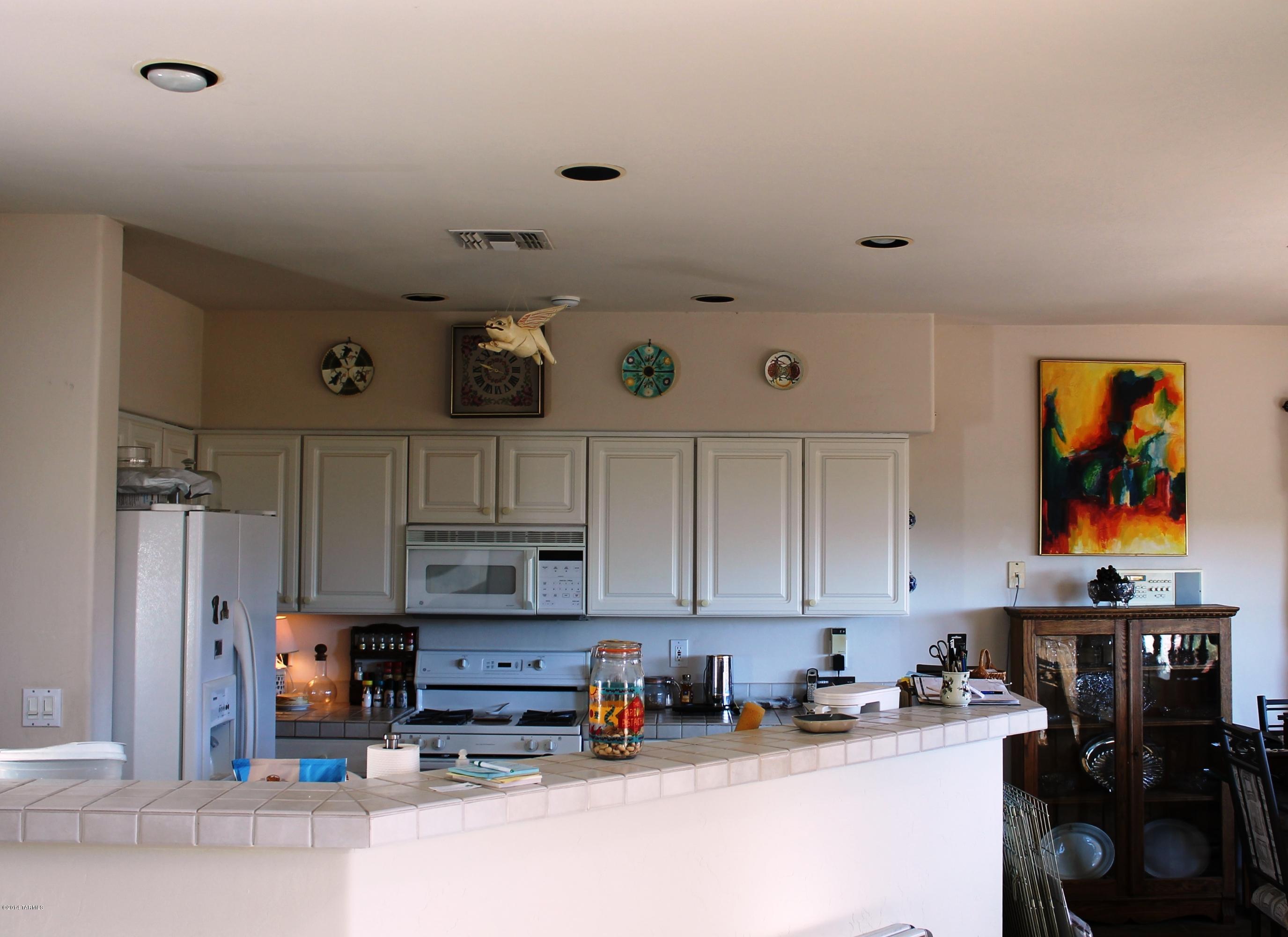 11286 North Copper Spring Trail Tucson, AZ 85737 - Photo 3 of 8 a kitchen with stainless steel appliances granite countertop a refrigerator and stove