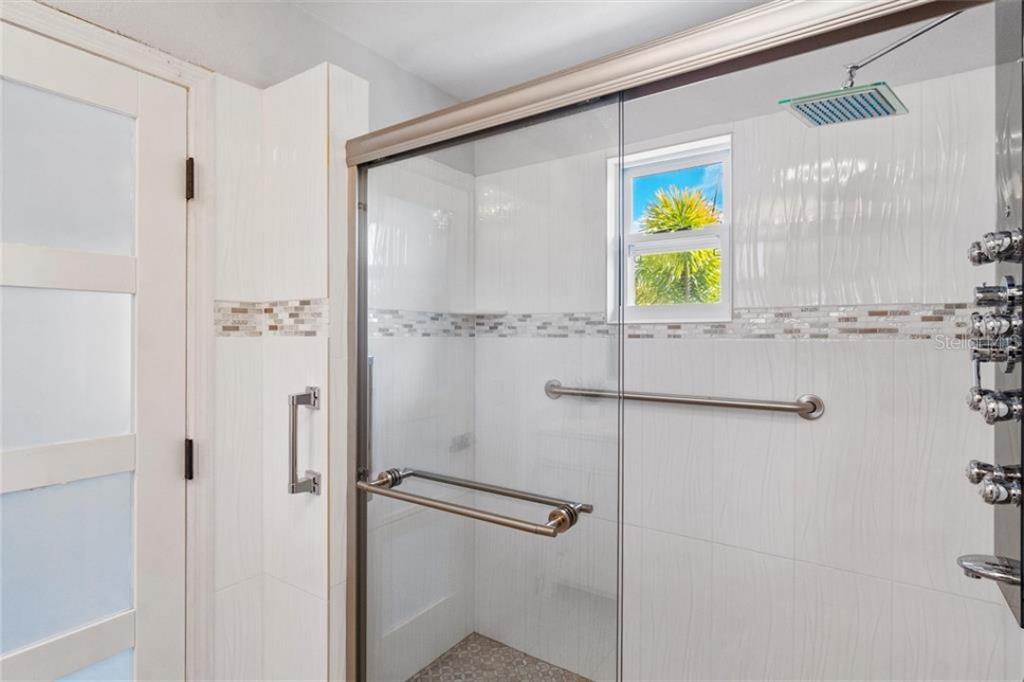 307 161st Avenue Redington Beach, FL 33708 - Photo 11 of 41 a bathroom with a window and a shower