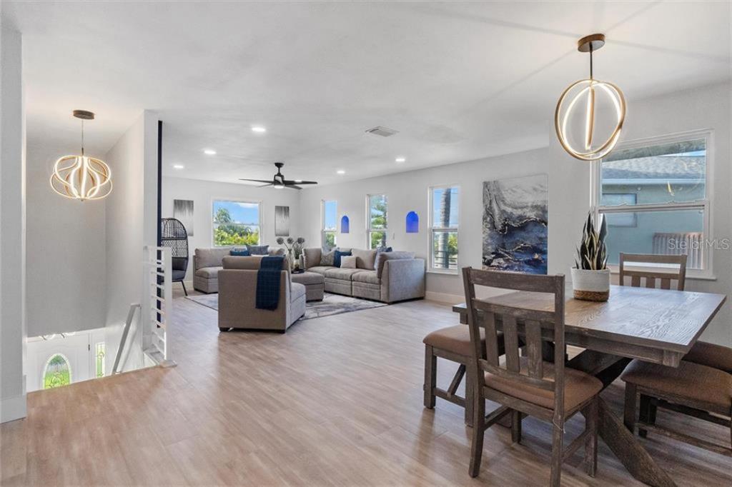 307 161st Avenue Redington Beach, FL 33708 - Photo 12 of 41 a living room with furniture kitchen view and a wooden floor