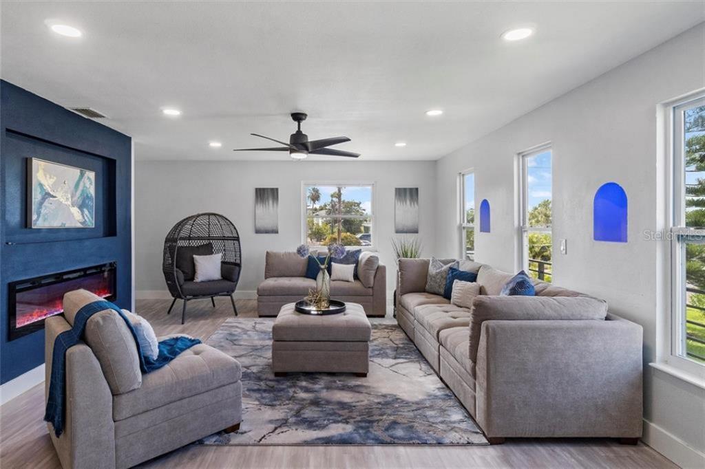 307 161st Avenue Redington Beach, FL 33708 - Photo 14 of 41 a living room with furniture potted plant and a fireplace