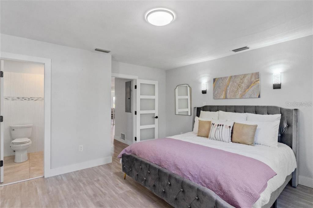 307 161st Avenue Redington Beach, FL 33708 - Photo 21 of 41 a bedroom with a bed and a view of bathroom