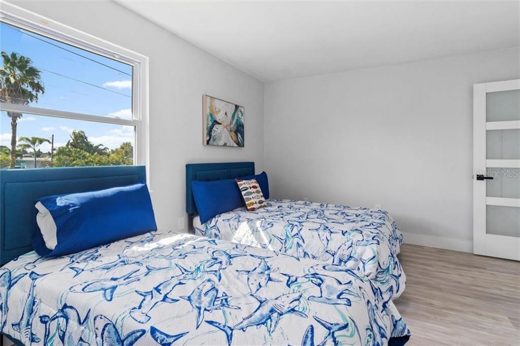 307 161st Avenue Redington Beach, FL 33708 - Photo 24 of 41 a bedroom with a large bed and a window