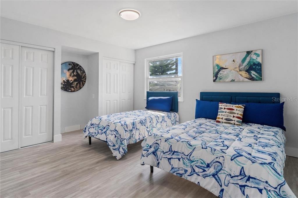 307 161st Avenue Redington Beach, FL 33708 - Photo 25 of 41 a bedroom with a large bed and a chandelier