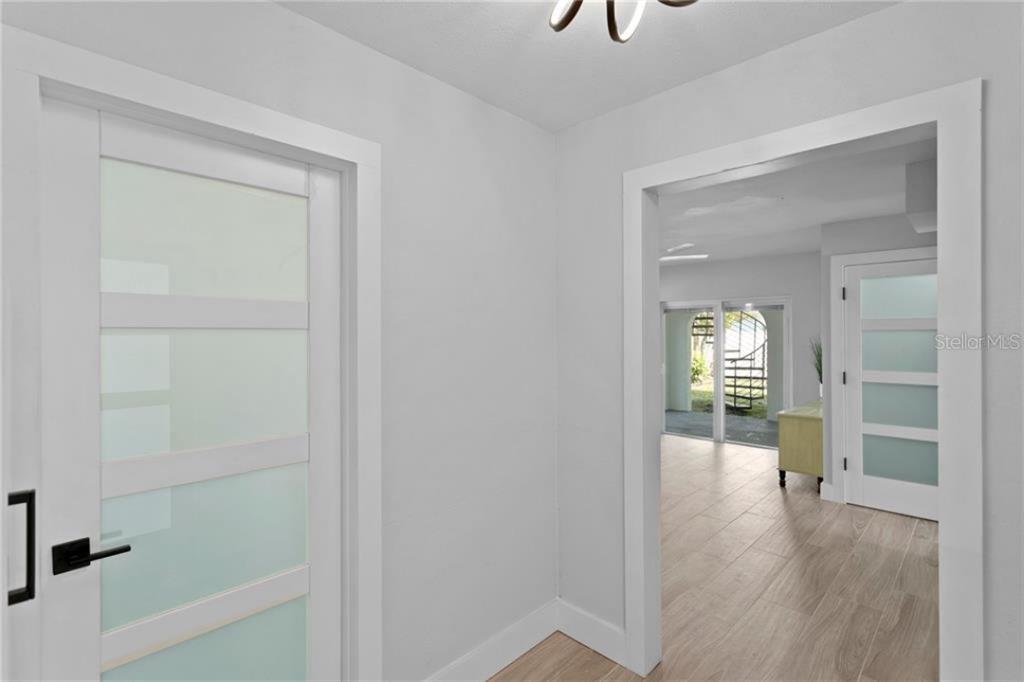 307 161st Avenue Redington Beach, FL 33708 - Photo 9 of 41 a view of a hallway view with wooden floor and living room