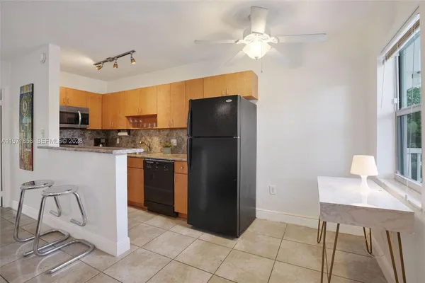 a kitchen with stainless steel appliances granite countertop a refrigerator and a stove top oven