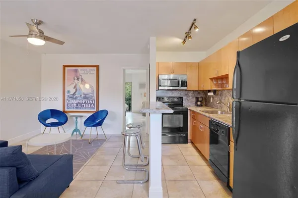 a kitchen with cabinets and stainless steel appliances