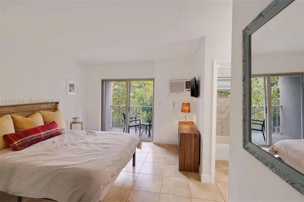 a bedroom with a large bed and a large window
