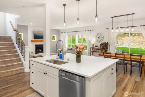 a kitchen with stainless steel appliances a sink a stove a refrigerator and cabinets