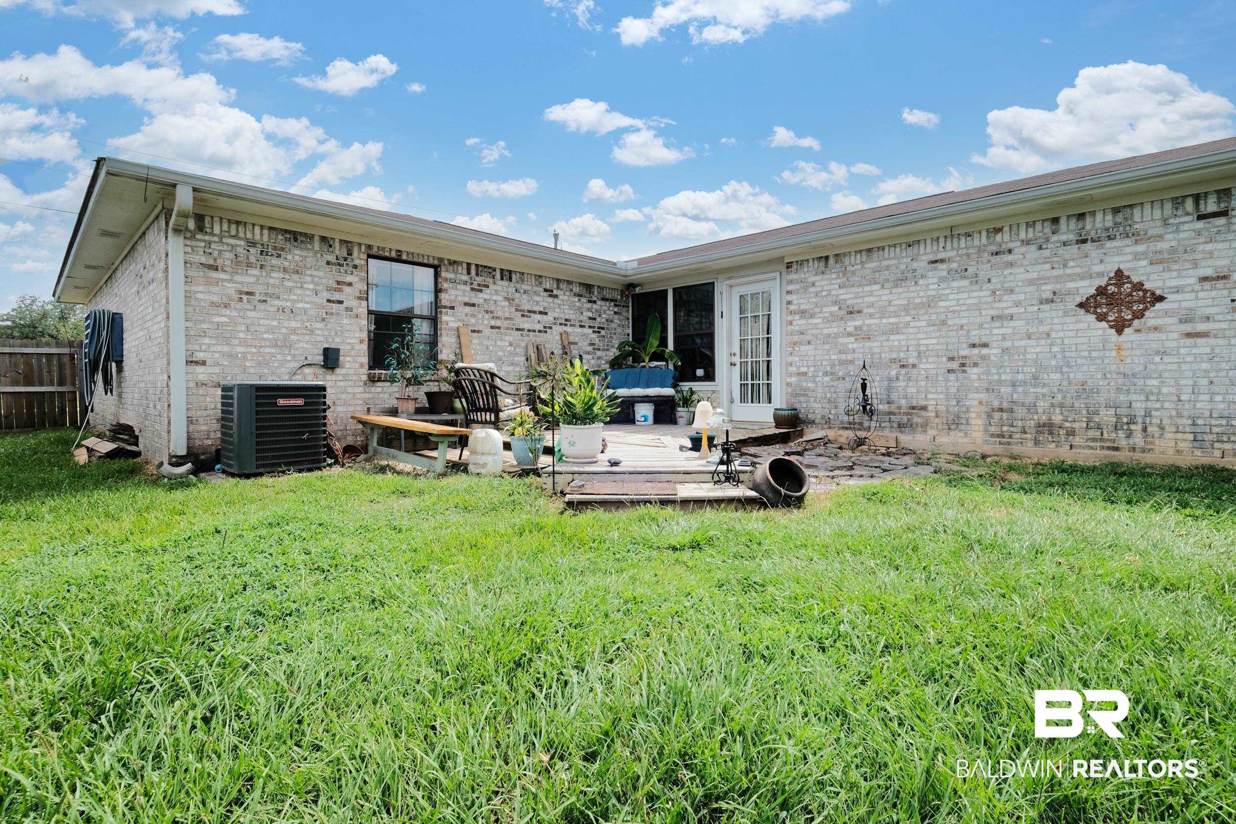504 Ariel Avenue Foley, AL 36535 - Photo 6 of 33 Back of property featuring a yard and central AC