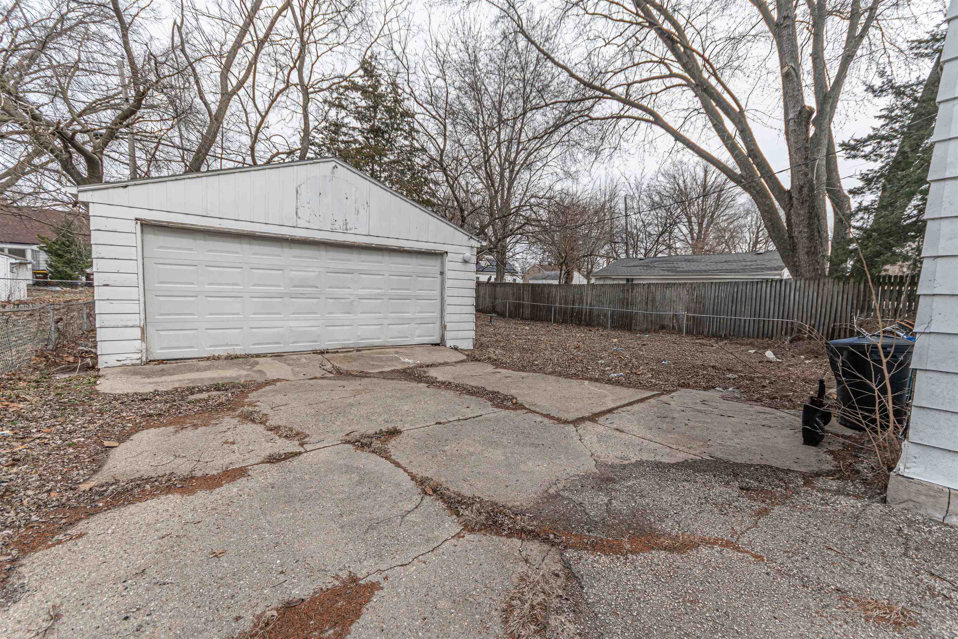 2827 Knight Avenue Rockford, IL 61101 - Photo 15 of 16 a backyard of a house with large trees and garage