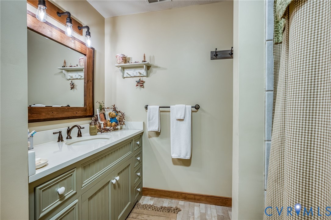 2081 Mill Road Henrico, VA 23231 - Photo 22 of 30 a bathroom with a double vanity sink and mirror