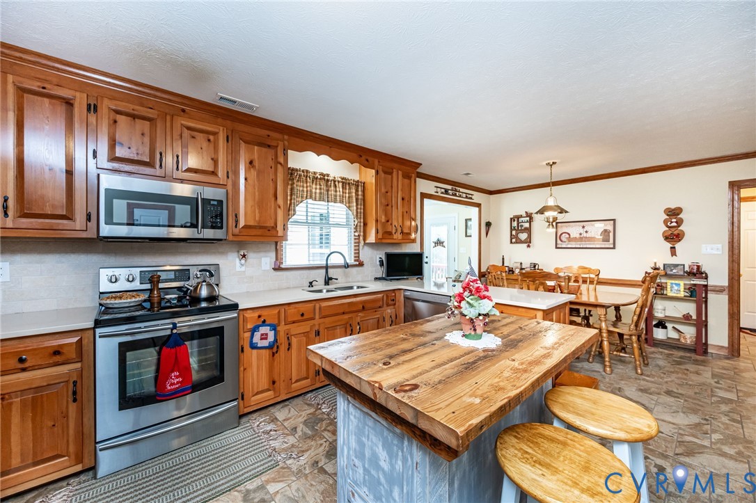 2081 Mill Road Henrico, VA 23231 - Photo 7 of 30 a kitchen with stainless steel appliances granite countertop a stove top oven a sink dishwasher and cabinets with wooden floor