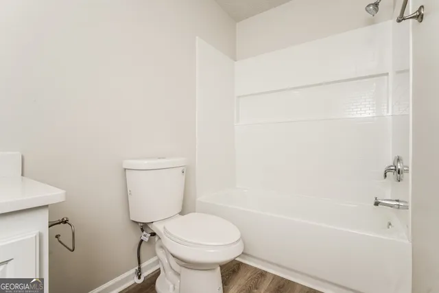 a bathroom with a toilet and a bathtub
