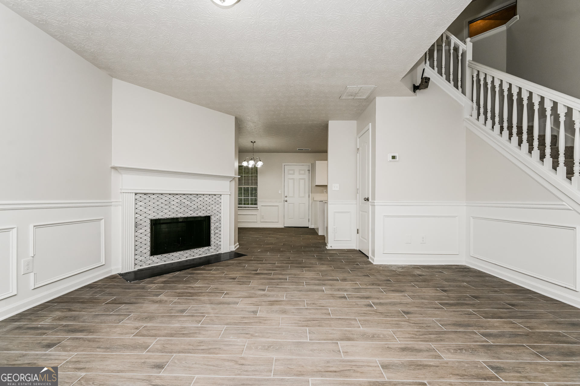 4392 Chester Lane Ellenwood, GA 30294 - Photo 4 of 17 a view of empty room with wooden floor and fireplace