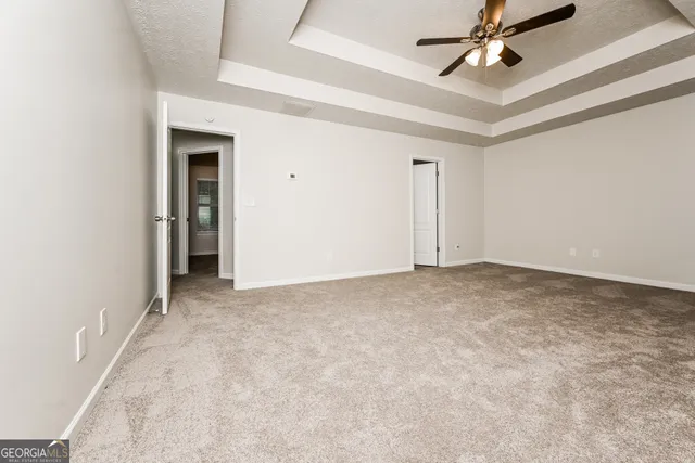 an empty room with a ceiling fan