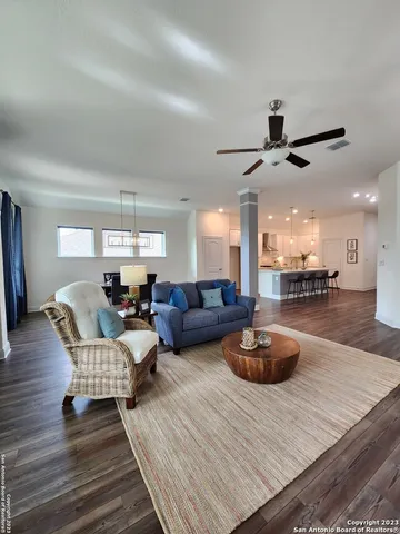 a living room with furniture and a wooden floor