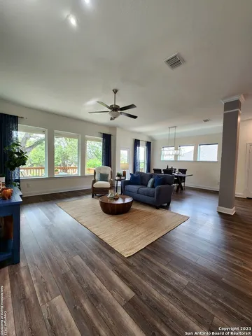 a living room with furniture and a wooden floor