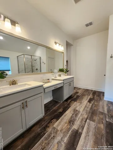 a spacious bathroom with a tub shower and mirror