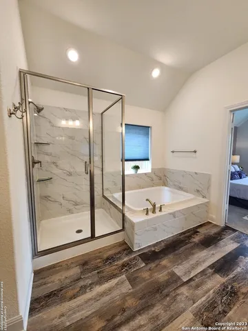 a bathroom with a tub and a view of bathroom