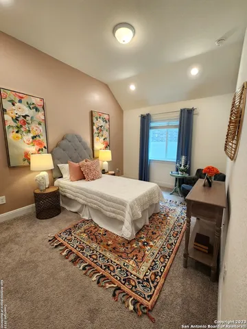 a bedroom with a bed and a couch