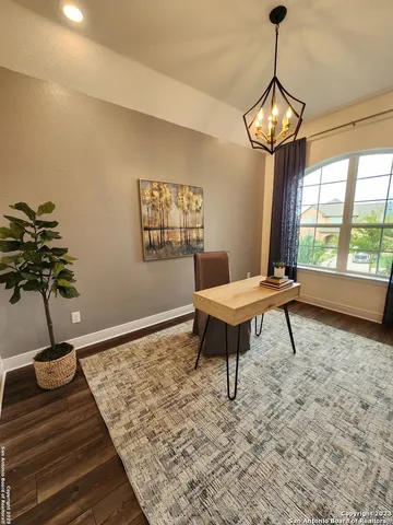 a roof deck with table and chairs and wooden floor
