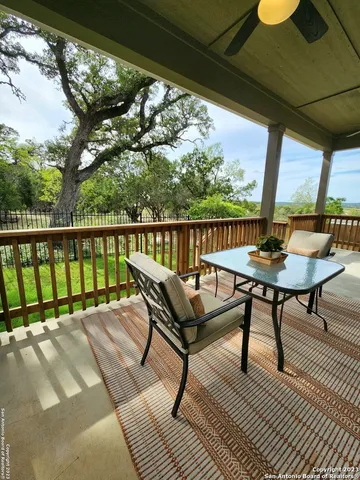 a roof deck with table and chairs and wooden floor